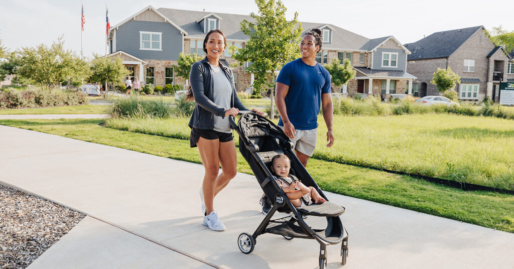 Homeowners walking in front of CB JENI townhome.