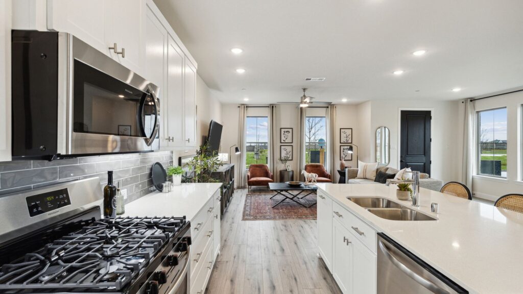 Kitchen and living room in the Hansen Floorplan of a CB JENI townhome.