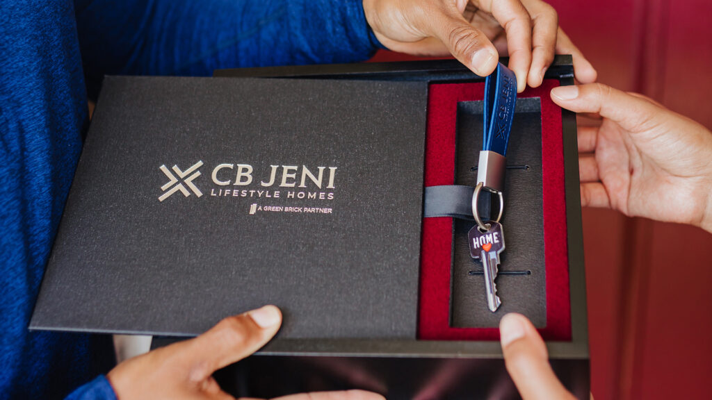 Hands holding the keys to a new CB JENI Homes townhome