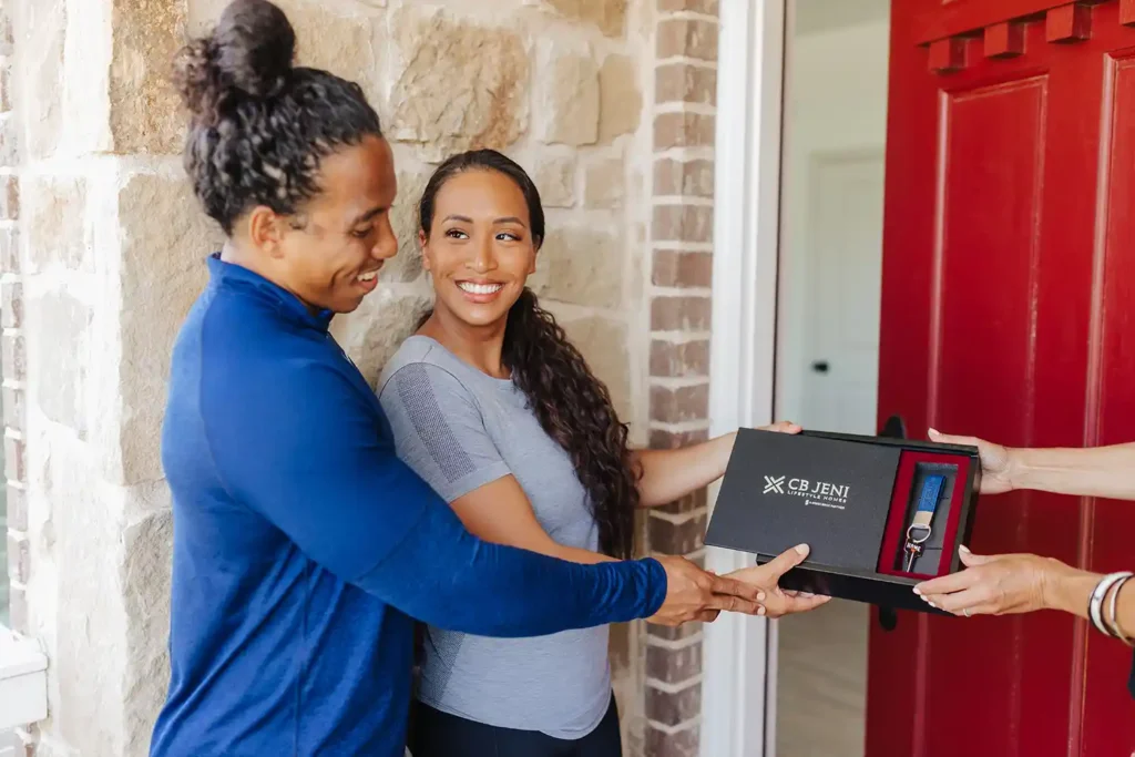 Couple accepting keys to CB JENI home