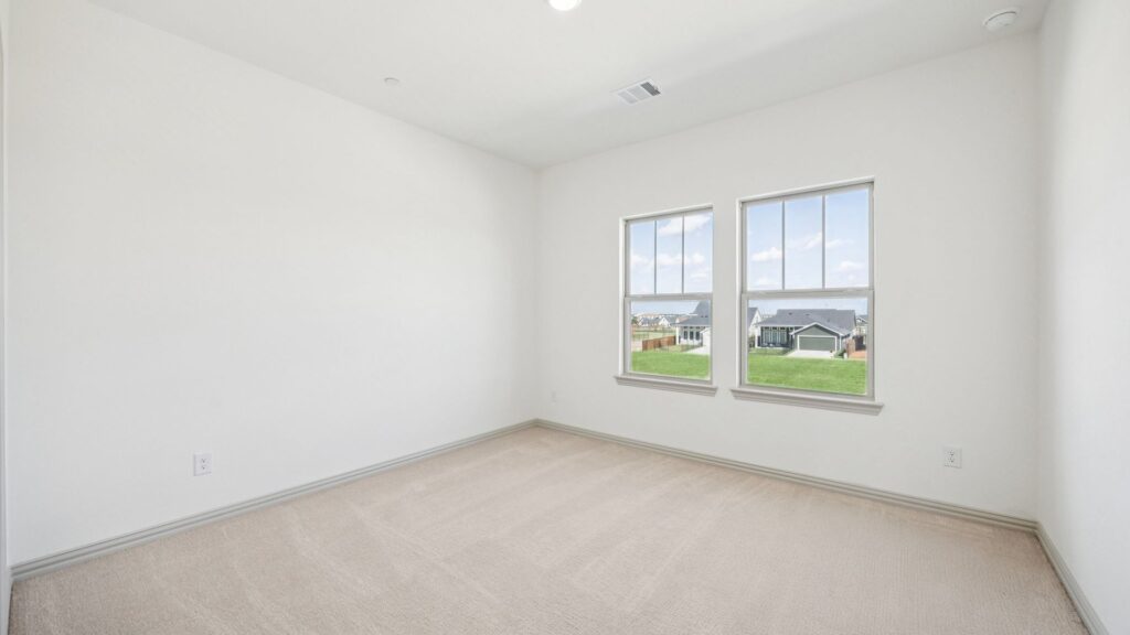 Bedroom 3 in the Emily Floorplan at The Village at Midtowne in Midlothian, TX.