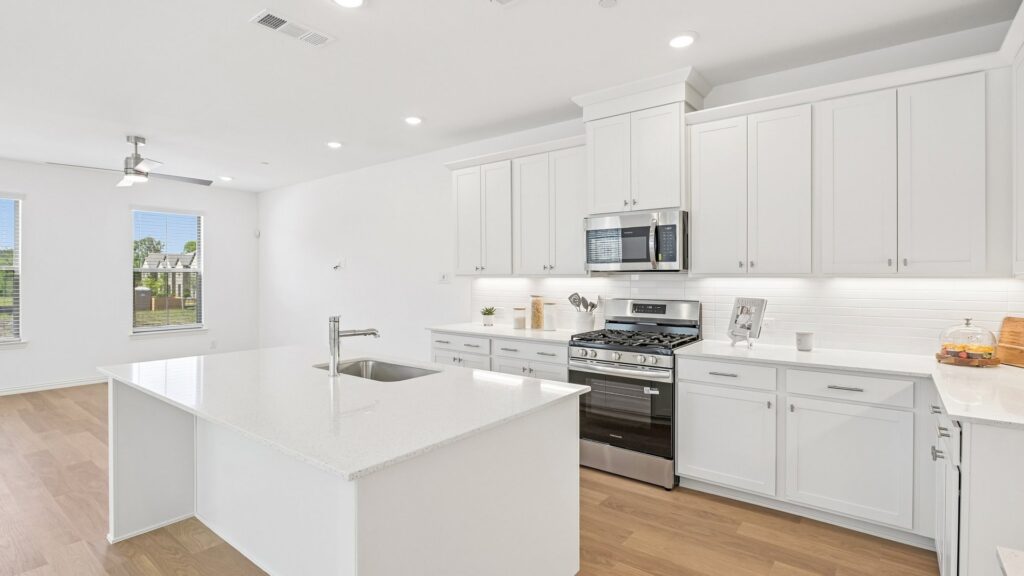 Kitchen in the Hansen floorplan at Painted Tree Woodland District in McKinney, TX.