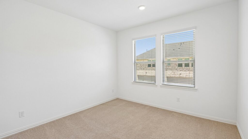 Secondary bedroom in the Hansen floorplan at Painted Tree Woodland District in McKinney, TX.