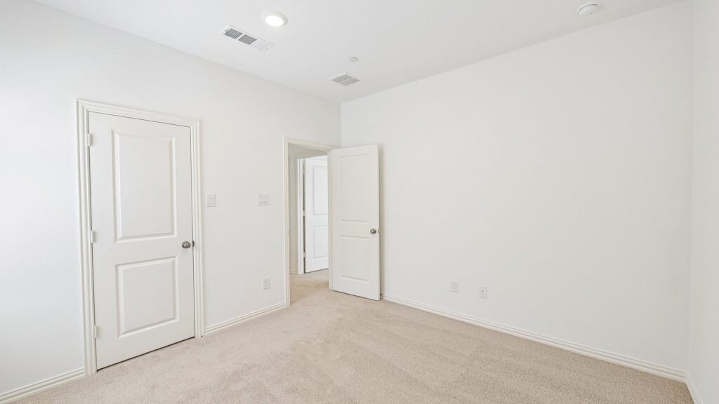 Secondary bedroom in the Hansen floorplan at Painted Tree Woodland District in McKinney, TX.